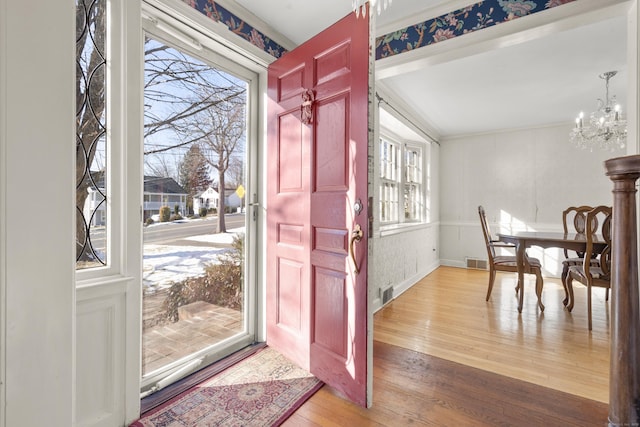 entryway featuring a notable chandelier, hardwood / wood-style flooring, and plenty of natural light