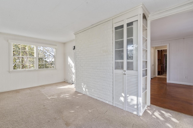 carpeted spare room with ornamental molding