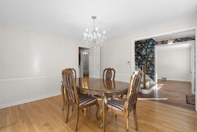 dining area featuring a chandelier and light hardwood / wood-style floors