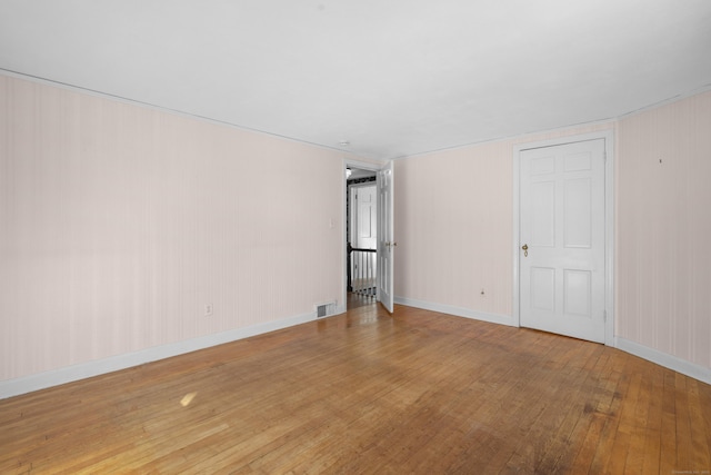 spare room with wood-type flooring