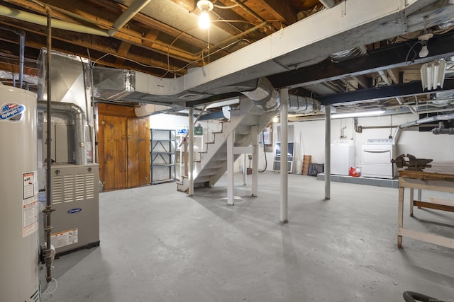 basement featuring water heater and washer and dryer