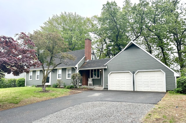4 Sparkle St, Enfield, CT 06082 - view of front of home with an attached garage, asphalt driveway, a chimney, a front yard, and a shingled roof
