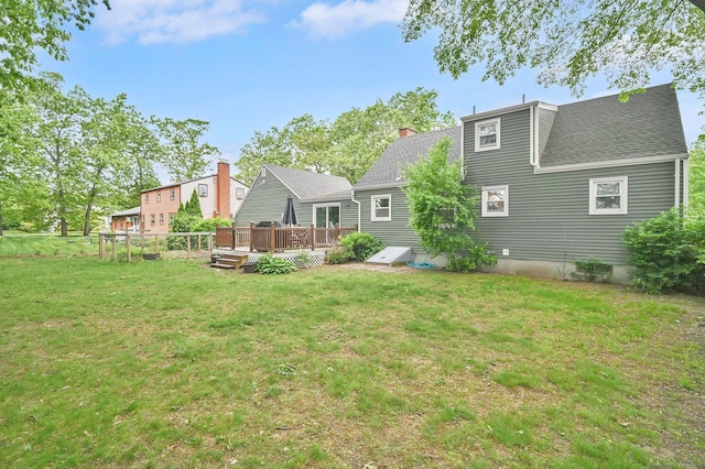 4 Sparkle St, Enfield, CT 06082 - back of property with a wooden deck, a lawn, and roof with shingles