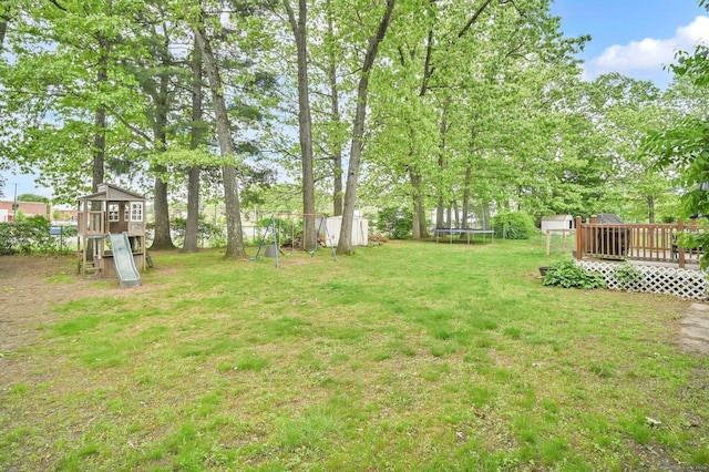 4 Sparkle St, Enfield, CT 06082 - view of green lawn featuring a trampoline, a playground, and a deck