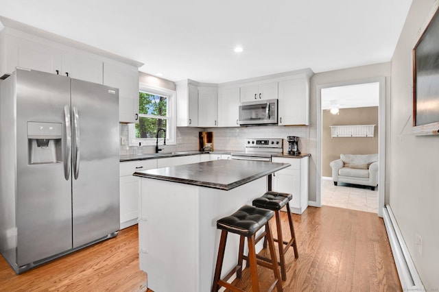 4 Sparkle St, Enfield, CT 06082 - kitchen with stainless steel appliances, a sink, light wood-style floors, dark countertops, and recessed lighting