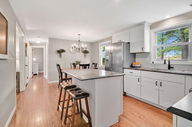 4 Sparkle St, Enfield, CT 06082 - kitchen with a sink, light wood finished floors, stainless steel fridge with ice dispenser, and white cabinetry