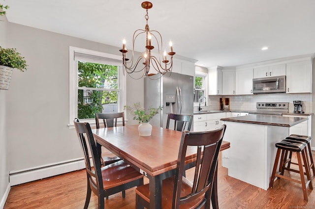 4 Sparkle St, Enfield, CT 06082 - dining area with baseboard heating, a chandelier, light wood-style flooring, and recessed lighting