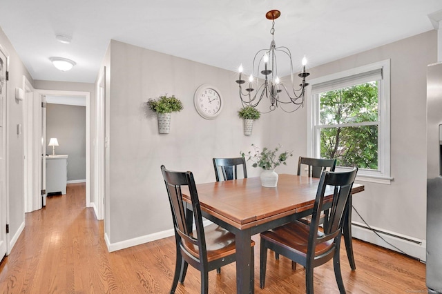 4 Sparkle St, Enfield, CT 06082 - dining space featuring a baseboard heating unit, light wood finished floors, a chandelier, and baseboards