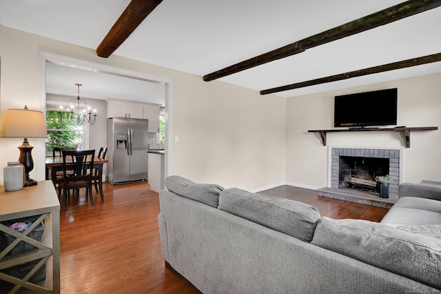 4 Sparkle St, Enfield, CT 06082 - living room with beamed ceiling, a chandelier, wood finished floors, a brick fireplace, and baseboards