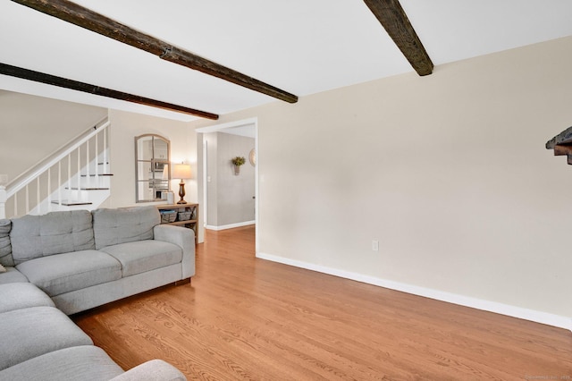 4 Sparkle St, Enfield, CT 06082 - living area with beam ceiling, wood finished floors, stairway, and baseboards
