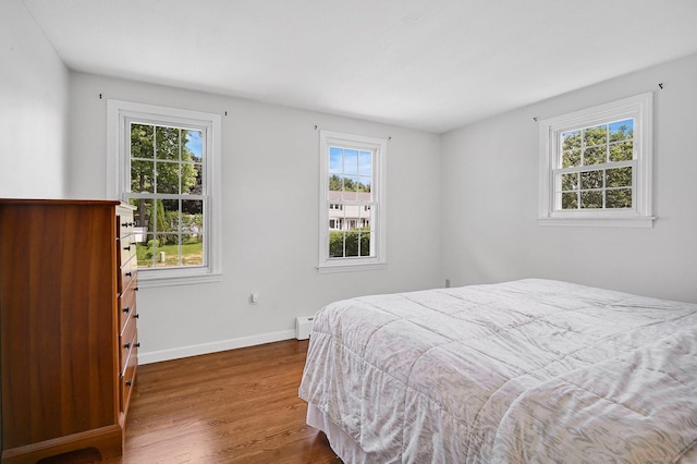 4 Sparkle St, Enfield, CT 06082 - bedroom featuring multiple windows, wood finished floors, baseboard heating, and baseboards
