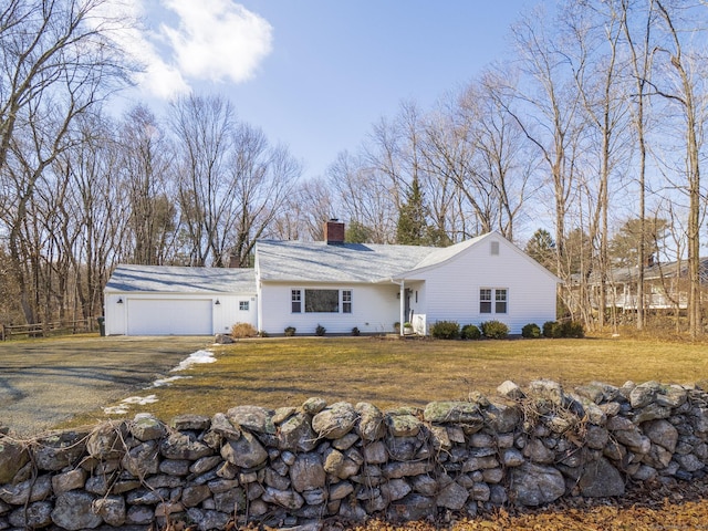 view of front facade featuring a garage, a front yard, fence, and a chimney