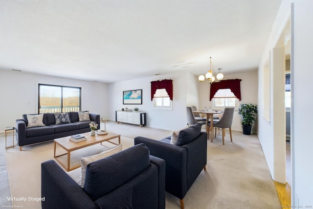 living area with an inviting chandelier, a wealth of natural light, and light colored carpet