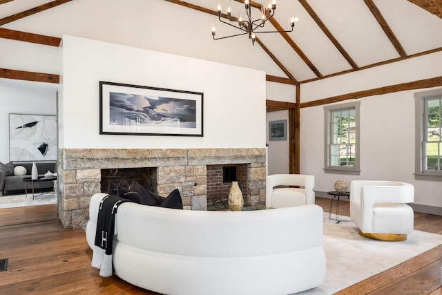 living room featuring beam ceiling, high vaulted ceiling, hardwood / wood-style flooring, and a fireplace