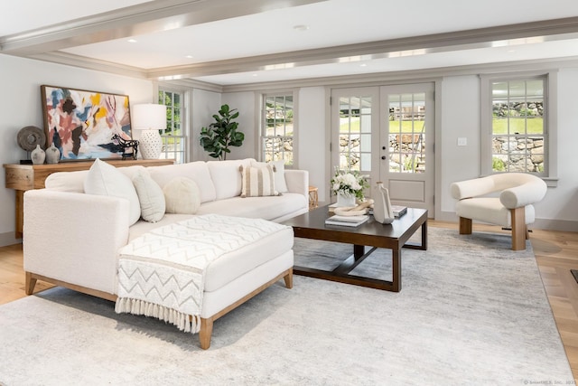 living room with light hardwood / wood-style flooring, ornamental molding, french doors, and plenty of natural light