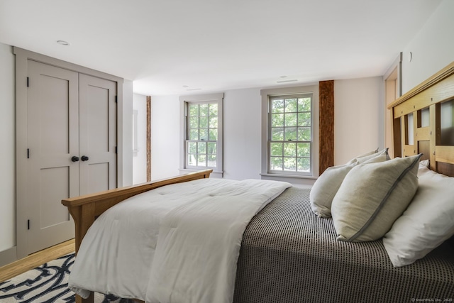 bedroom featuring light wood-type flooring and a closet