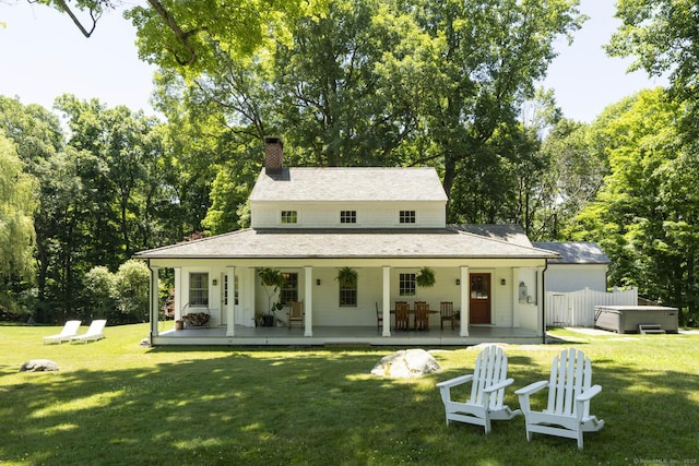 exterior space with a yard, a patio area, and a hot tub