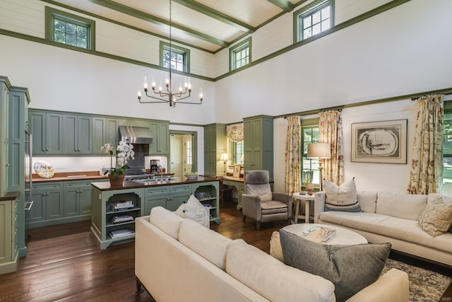 living room with a notable chandelier, dark wood-type flooring, and a high ceiling