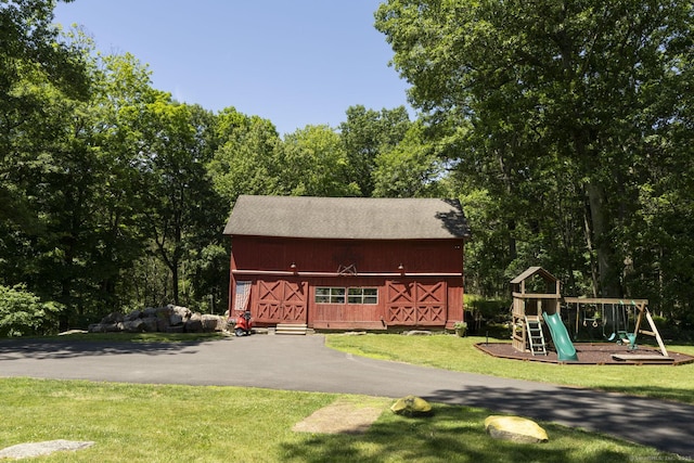 exterior space with a yard and a playground