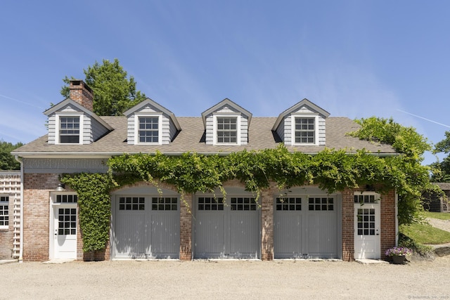 new england style home with a garage