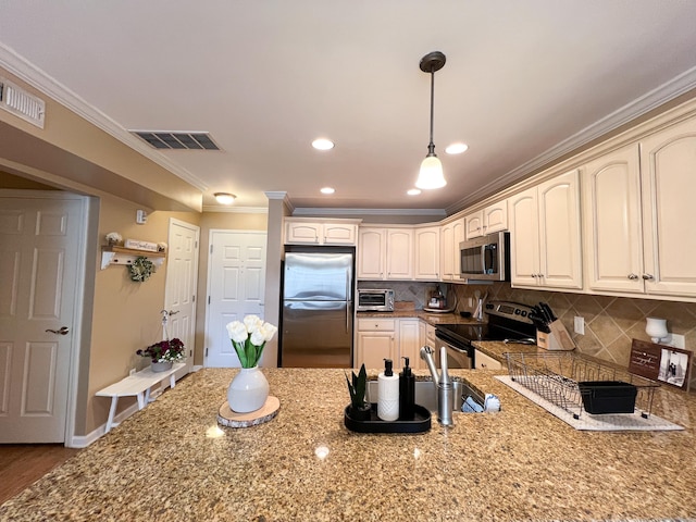 kitchen with stainless steel appliances, ornamental molding, light stone countertops, and backsplash