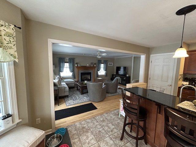 interior space featuring light tile patterned floors and ceiling fan