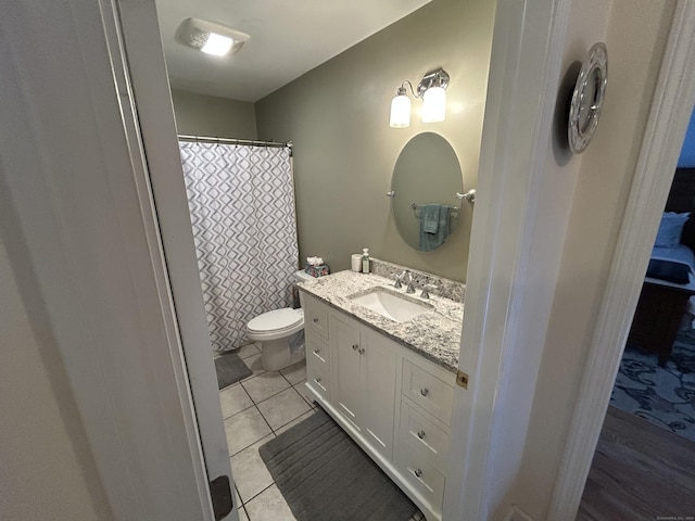 bathroom with vanity, tile patterned flooring, and toilet