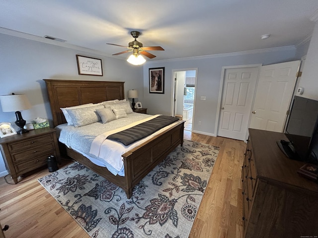 bedroom with ceiling fan, ornamental molding, connected bathroom, and light hardwood / wood-style floors