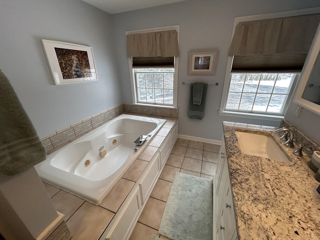 bathroom featuring vanity, tile patterned flooring, and tiled tub