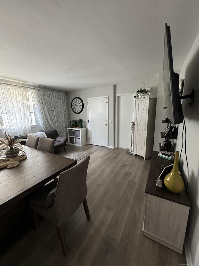 dining space with dark wood-type flooring