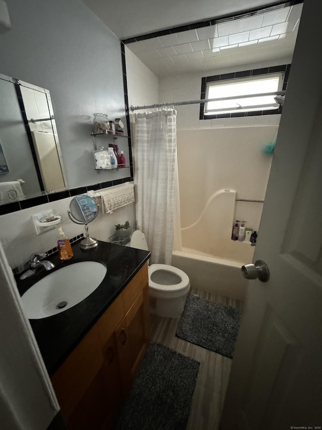 full bathroom featuring vanity, toilet, shower / bath combination with curtain, and hardwood / wood-style flooring