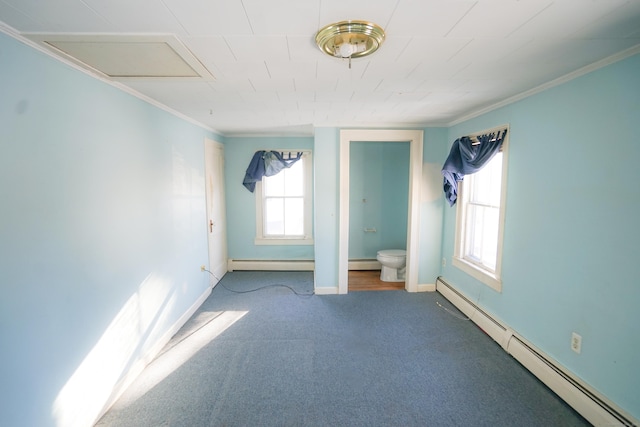 spare room featuring crown molding, carpet floors, and baseboard heating