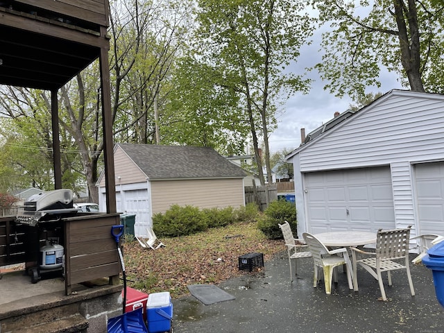 view of yard with a garage and an outdoor structure