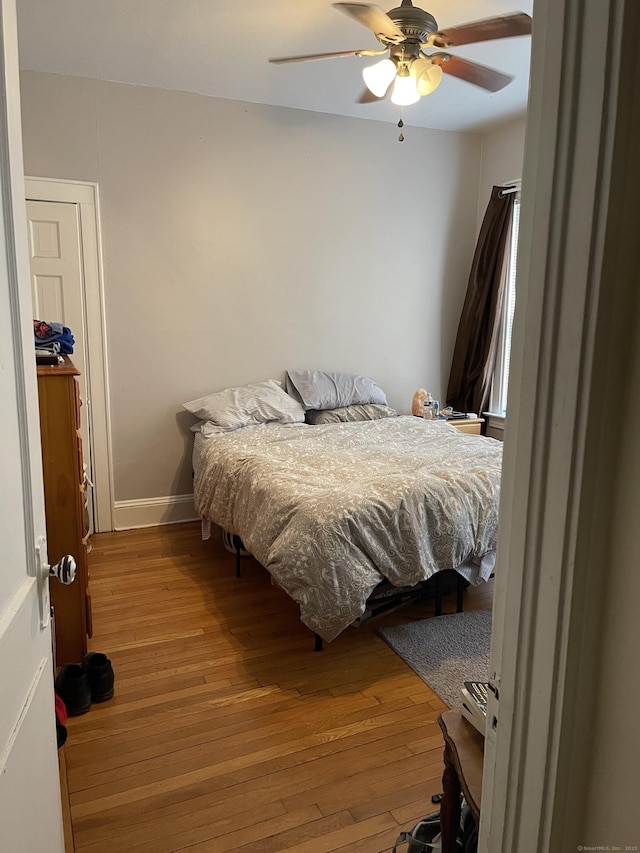 bedroom featuring ceiling fan and hardwood / wood-style flooring