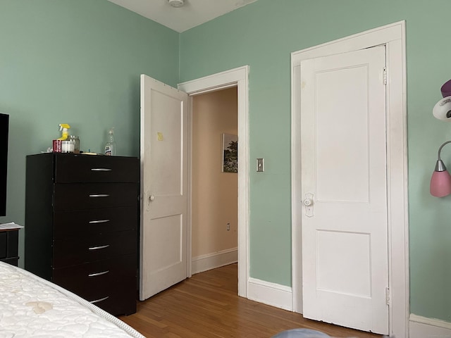 bedroom with hardwood / wood-style flooring