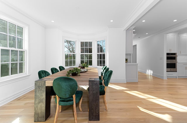 dining room with ornamental molding and plenty of natural light