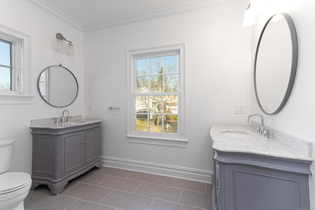 bathroom with vanity, toilet, crown molding, and tile patterned flooring