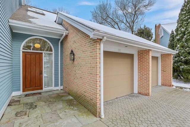 view of exterior entry featuring a garage