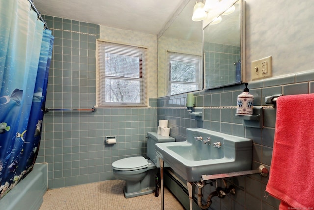 bathroom with tile walls, tile patterned floors, toilet, and shower / bathtub combination with curtain