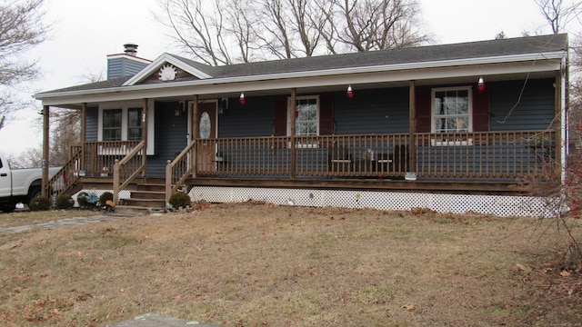 view of front facade with covered porch and a front yard