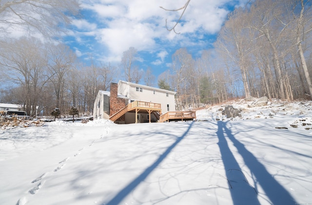 snow covered property featuring a deck