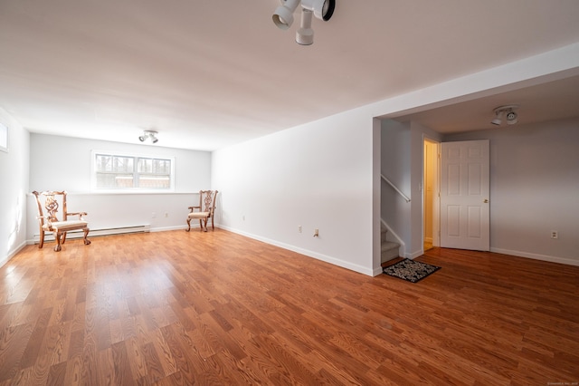 interior space featuring baseboard heating and hardwood / wood-style floors