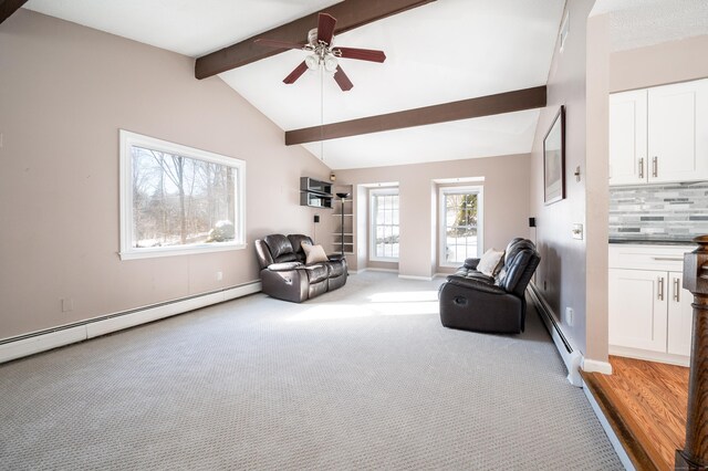 sitting room featuring light carpet, a baseboard heating unit, vaulted ceiling with beams, and ceiling fan