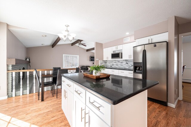 kitchen with hardwood / wood-style floors, tasteful backsplash, white cabinets, a center island, and stainless steel appliances