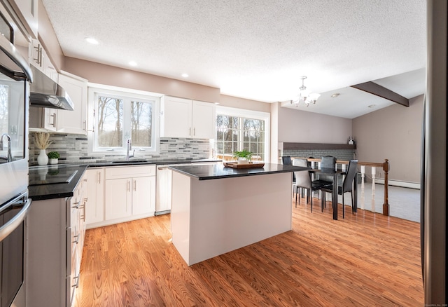 kitchen featuring a baseboard heating unit, a kitchen island, and white cabinets