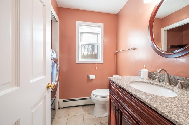 bathroom with vanity, tile patterned floors, toilet, and baseboard heating