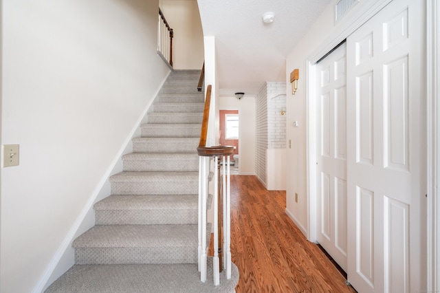 stairway featuring wood-type flooring