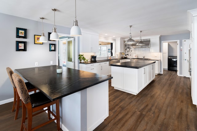 kitchen with white cabinetry, decorative light fixtures, and decorative backsplash