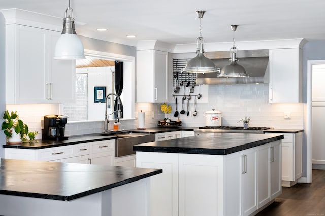 kitchen with hanging light fixtures, a center island, and white cabinets