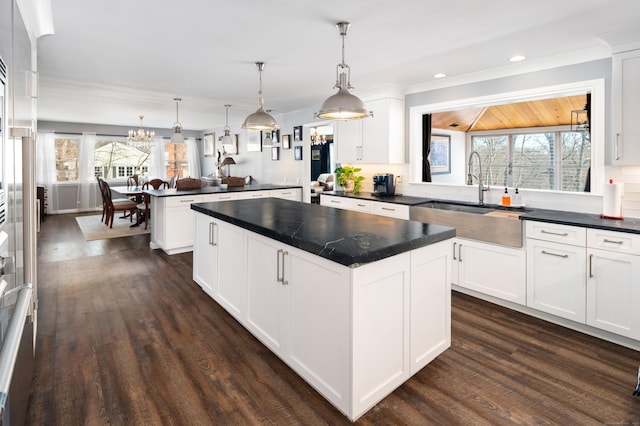 kitchen with a kitchen island, kitchen peninsula, hanging light fixtures, and white cabinets